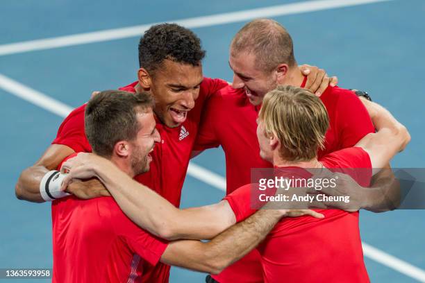 Felix Auger-Aliassume, Denis Shapovalov of Canada celebrate victory with Team Canada in the final match against Roberto Bautista Agut of Spain during...