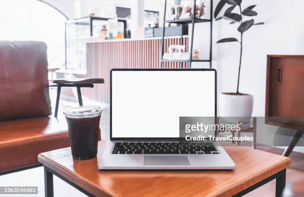 laptop computer blank screen on table in cafe background. laptop with blank screen on table of coffee shop blur background. - coffee table front view stock pictures, royalty-free photos & images