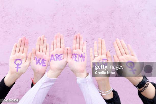 three young females claiming their rights as women on women's day. we are feminist writing in hands. - committee of public security and fight stock pictures, royalty-free photos & images