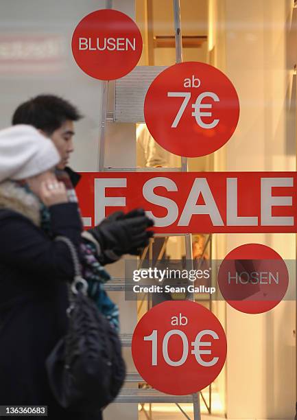 People walk past a store advertising sales on January 3, 2012 in Berlin, Germany. Many German retailers are offering heavy discounts in the weeks...