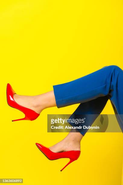 beautiful woman legs in high heel shoes on a colored yellow background. fashion concept - beautiful legs in high heels stock pictures, royalty-free photos & images