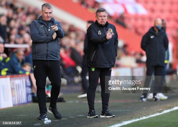 Dean Smith, Manager of Norwich City and Assistant Head Coach Craig Shakespeare give instructions during the Emirates FA Cup Third Round match between...