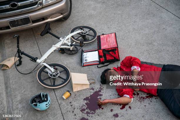 food delivery man bike accident - fahrrad kurier stock-fotos und bilder