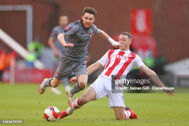 Paul Smyth of Leyton Orient is tackled by James Chester of Stoke City during the Emirates FA Cup Third Round match between Stoke City and Leyton...