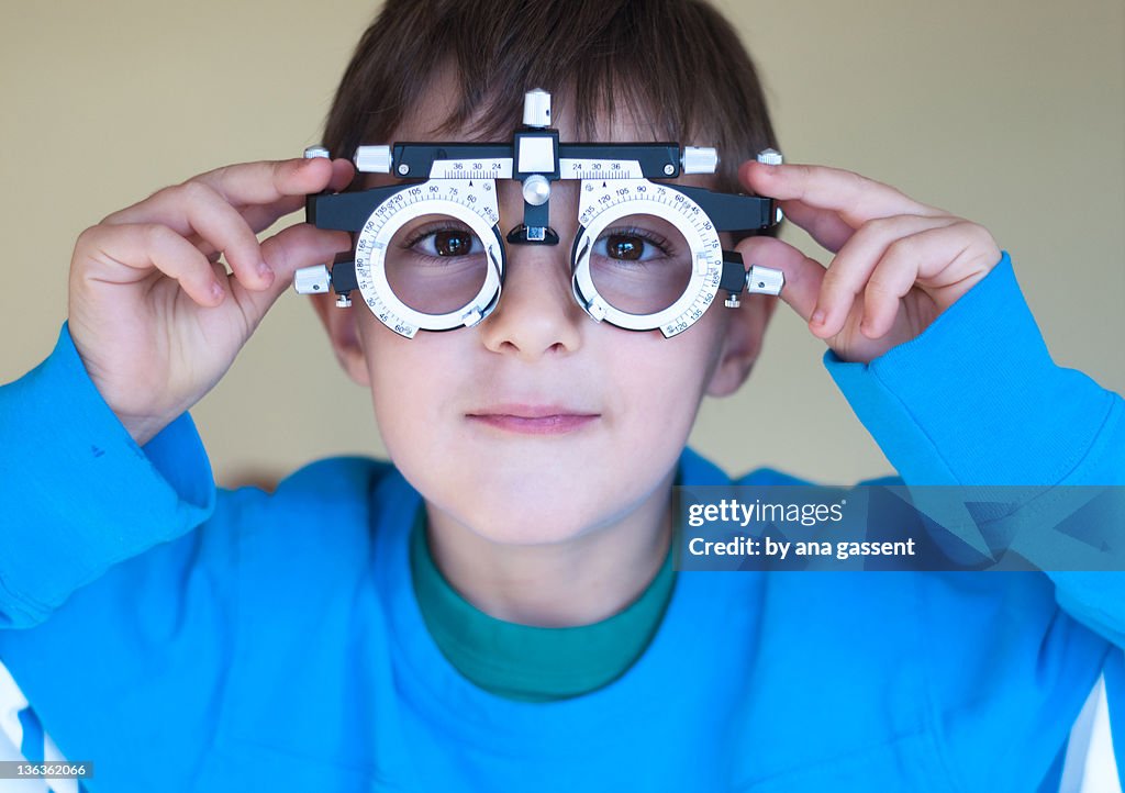 Boy wearing opticians glasses