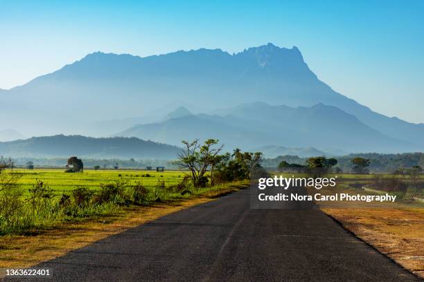 close up of mt. kinabalu and a rural road - sabah state stock pictures, royalty-free photos & images