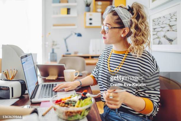 working at home - eating vegan food stock pictures, royalty-free photos & images