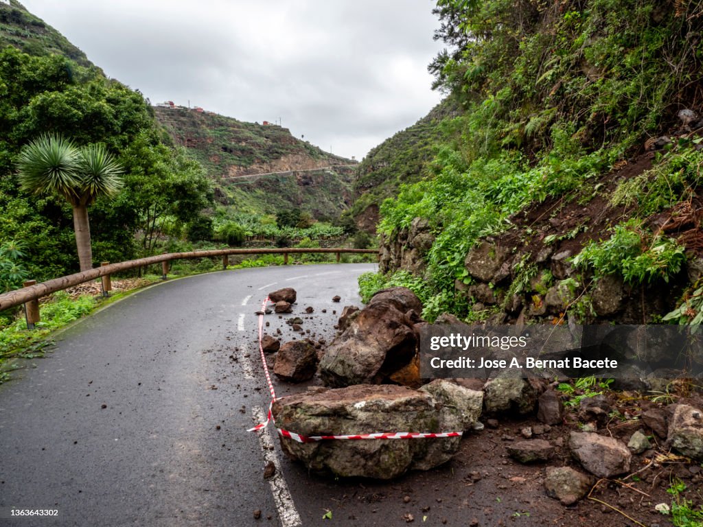 Road cut by rockslides on the road.