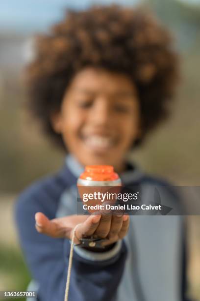 boy playing with his spinning top - peonza stockfoto's en -beelden