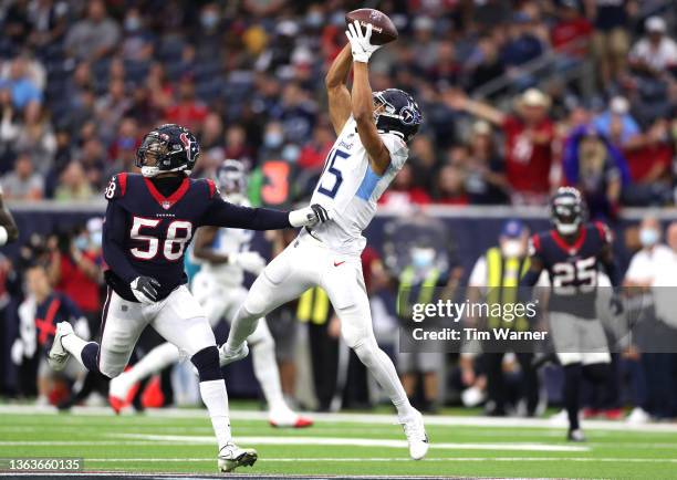 Nick Westbrook-Ikhine of the Tennessee Titans catches a pass over Christian Kirksey of the Houston Texans during the first quarter at NRG Stadium on...