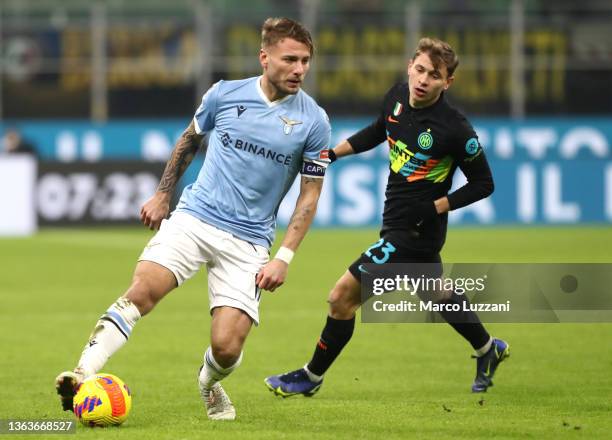 Ciro Immobile of SS Lazio is challenged by Nicolo Barella of FC Internazionale during the Serie A match between FC Internazionale v SS Lazio at...