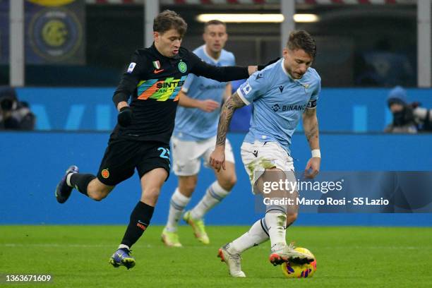 Ciro Immobile of SS Lazio compete for the ball with Nicolò Barella of FC Internazionale during the Serie A match between FC Internazionale v SS Lazio...