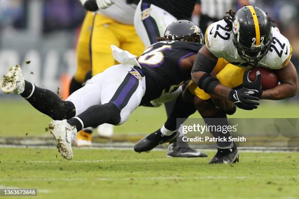 Najee Harris of the Pittsburgh Steelers runs the ball and tackled by Josh Bynes of the Baltimore Ravens during the third quarter at M&T Bank Stadium...