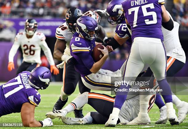 Kirk Cousins of the Minnesota Vikings is sacked by Bilal Nichols and Robert Quinn of the Chicago Bears in the second half of the game at U.S. Bank...