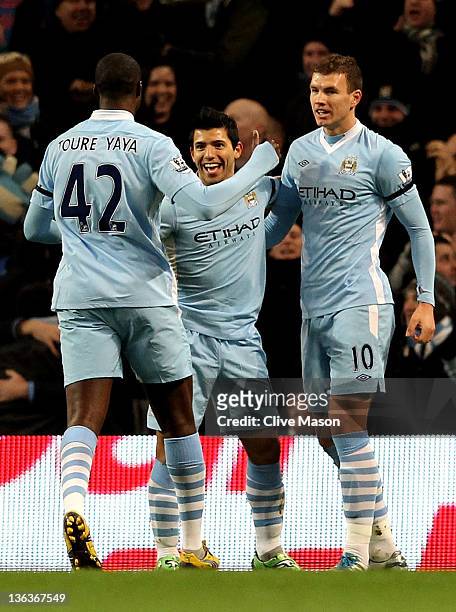 Sergio Aguero of Manchester City celebrates with his team mates Yaya Toure and Edin Dzeko after scoring the opening goal during the Barclays Premier...