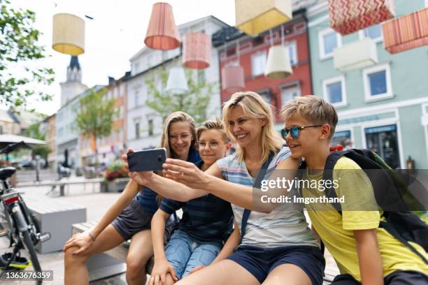 family sightseeing a beautiful austrian town of villach - villach stock pictures, royalty-free photos & images