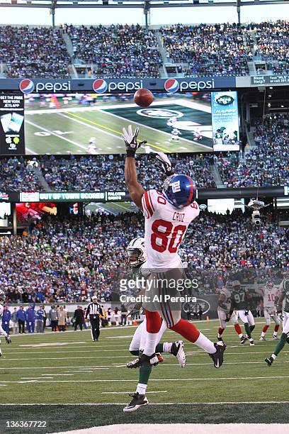 Wide Receiver Victor Cruz of the New York Giants reaches for a ball in the end zone when the New York Jets host the New York Giants at MetLife...
