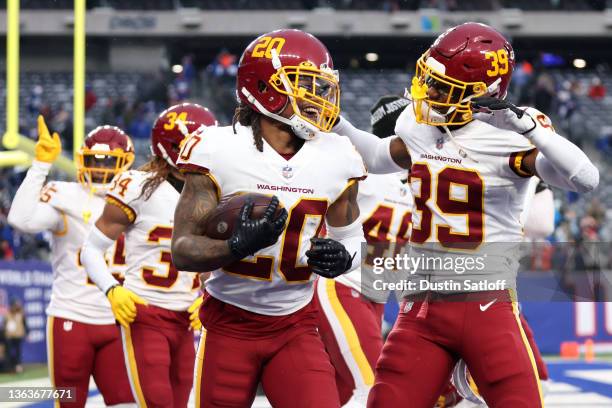 Bobby McCain of the Washington Football Team celebrates after getting an interception with teammate Jeremy Reaves in the fourth quarter of the game...