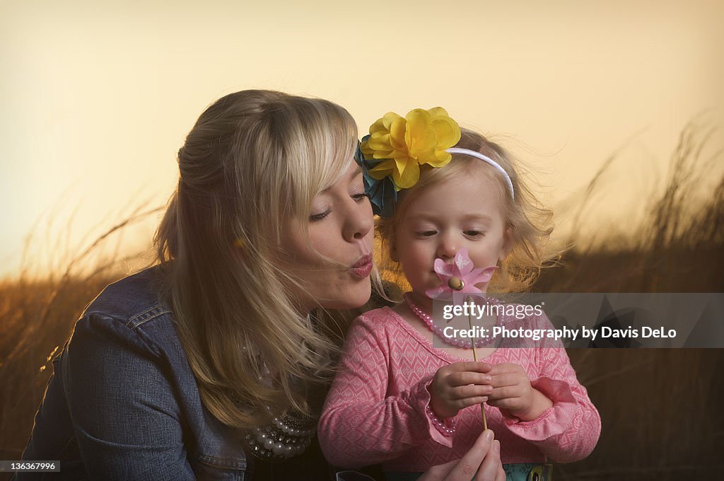 Mother and baby girl in field