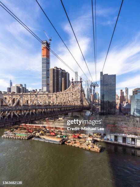 view of queensboro bridge and midtown manhattan skyline from cable car in new york - midtown manhattan stock pictures, royalty-free photos & images