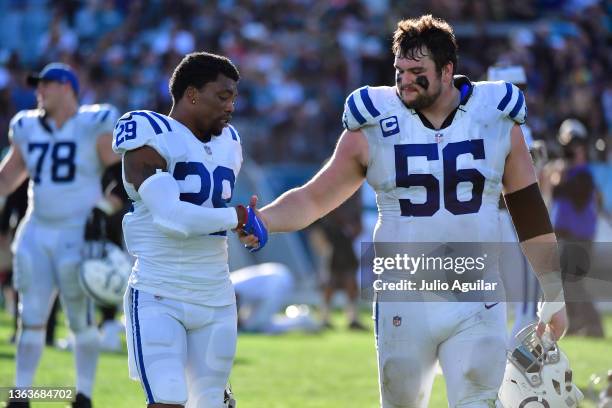 Will Redmond and Quenton Nelson of the Indianapolis Colts shake hands after a loss to the Jacksonville Jaguars at TIAA Bank Field on January 09, 2022...