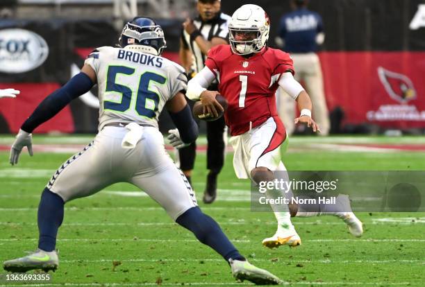 Kyler Murray of the Arizona Cardinals runs the ball in front of Jordyn Brooks of the Seattle Seahawks during the second quarter at State Farm Stadium...