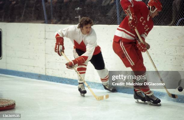 Bobby Clarke of Canada looks to steal the puck from Yuri Shatalov of the Soviet Union during the 1972 Summit Series at the Luzhniki Ice Palace in...