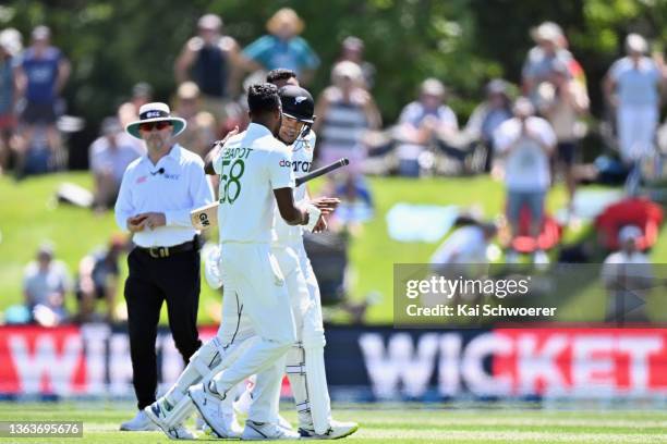 Ross Taylor of New Zealand is comforted by Ebadot Hossain Chowdhury of Bangladesh after being dismissed for 28 runs during day two of the Second Test...