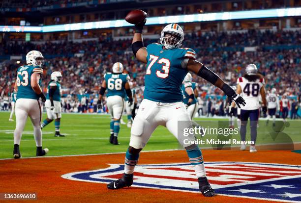 Austin Jackson of the Miami Dolphins spikes the ball after Duke Johnson rushed for a touchdown in the third quarter of the game against the New...