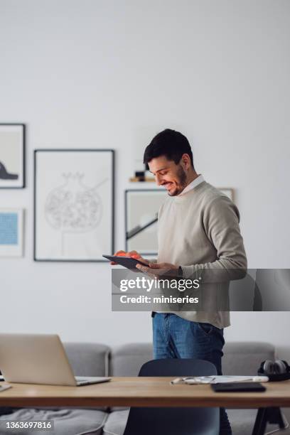 home office: man using a digital tablet - man look side stock pictures, royalty-free photos & images