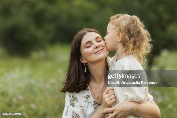 beautiful mother and daughter having fun outdoor. - toddler girl dress stockfoto's en -beelden