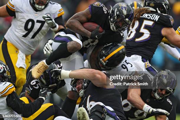 Latavius Murray of the Baltimore Ravens rushes with the ball as he is tackled by Chris Wormley of the Pittsburgh Steelers during the third quarter at...