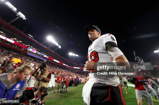 Tom Brady of the Tampa Bay Buccaneers runs off the field after defeating the Carolina Panthers at Raymond James Stadium on January 09, 2022 in Tampa,...