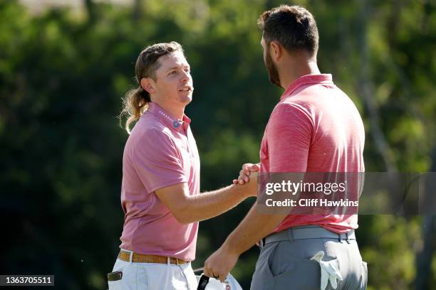 Jon Rahm of Spain congratulates Cameron Smith of Australia after winning on the 18th green during the final round of the Sentry Tournament of...
