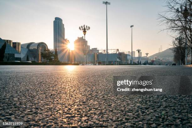 city road at sunset - solar street light stock pictures, royalty-free photos & images