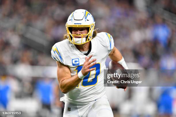 Justin Herbert of the Los Angeles Chargers rushes the ball during the second quarter against the Las Vegas Raiders at Allegiant Stadium on January...