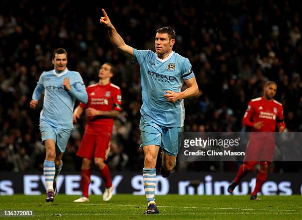 James Milner of Manchester City celebrates scoring his team's third goal, from a penalty kick, during the Barclays Premier League match between...