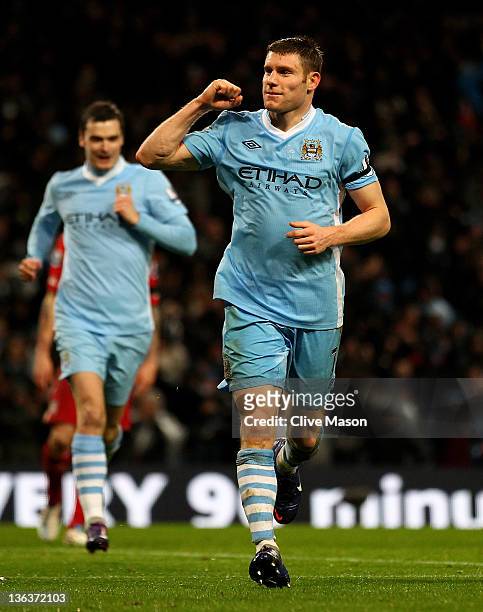 James Milner of Manchester City celebrates scoring his team's third goal, from a penalty kick, during the Barclays Premier League match between...