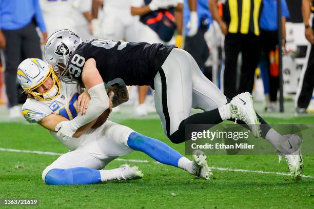 Maxx Crosby of the Las Vegas Raiders sacks Justin Herbert of the Los Angeles Chargers during the third quarter at Allegiant Stadium on January 09,...