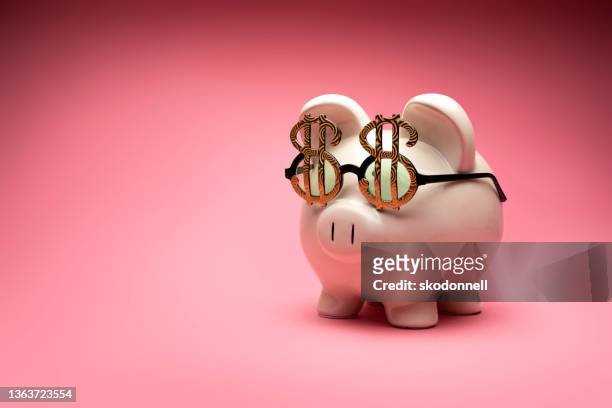 concept photo of a white large piggy bank on pink background - big sunglasses stock pictures, royalty-free photos & images