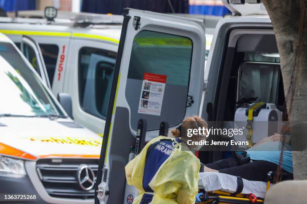 Paramedic unloads a patient from an ambulance at Royal Prince Alfred Hospital on January 10, 2022 in Sydney, Australia. NSW has recorded 18 deaths in...