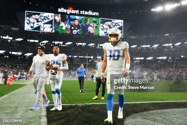 Justin Herbert of the Los Angeles Chargers walks offsides the field after being defeated by the Las Vegas Raiders at Allegiant Stadium on January 09,...