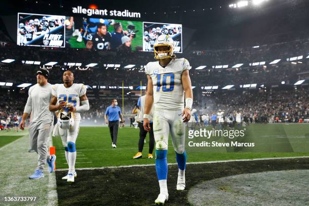 Justin Herbert of the Los Angeles Chargers walks off the field after being defeated by the Las Vegas Raiders at Allegiant Stadium on January 09, 2022...