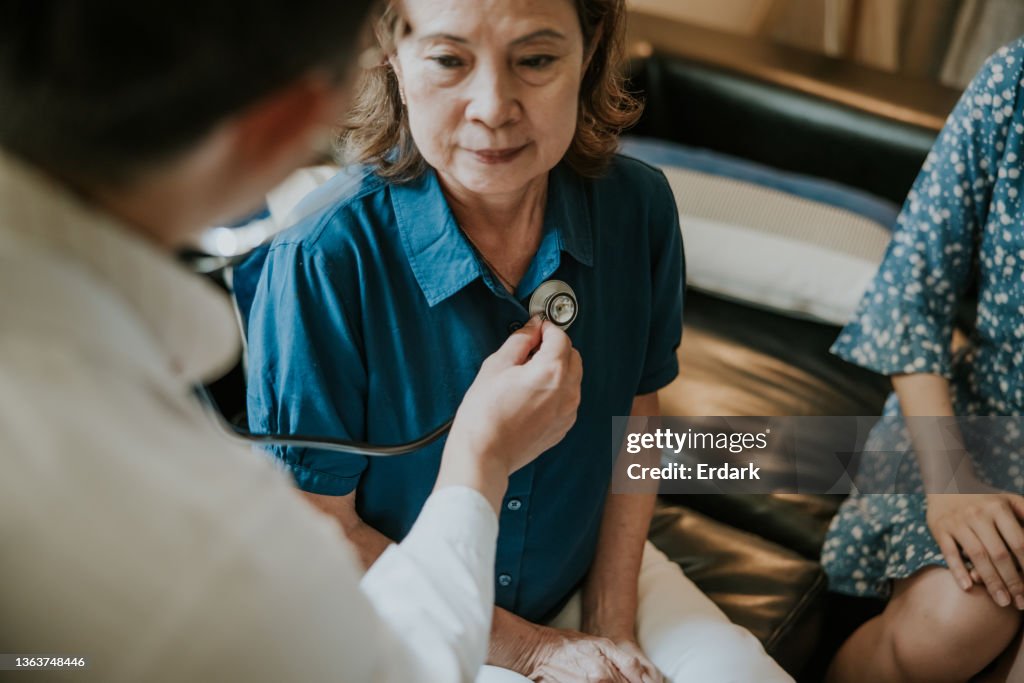 Close-up, Asian Doctor concentrate on listening heartbeat of senior woman.