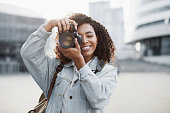 Woman photographer with digital camera outdoor portrait