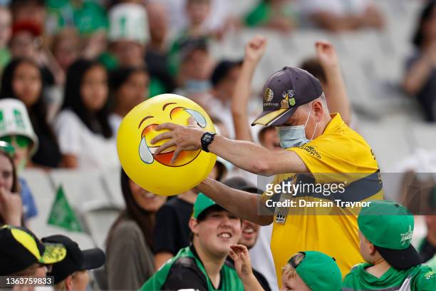 An M.C.G. Security staff member removes an inflatable beach ball from the crowd during the Men's Big Bash League match between the Melbourne Stars...