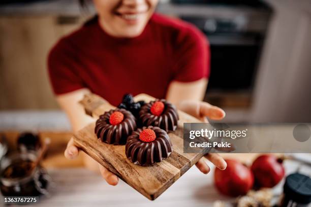 woman showing off her work - pound cake stock pictures, royalty-free photos & images