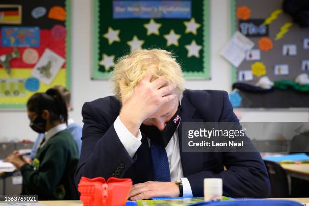 Britain's Prime Minister Boris Johnson speaks with pupils in a maths class as he makes a constituency visit to Oakwood School on January 10, 2022 in...