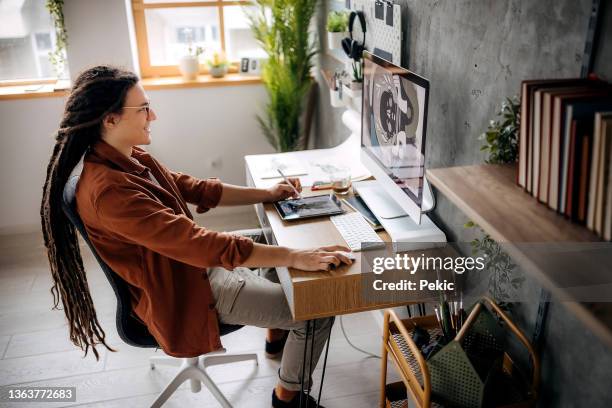 young casually clothed graphic designer working from his home office - illustrator stock pictures, royalty-free photos & images