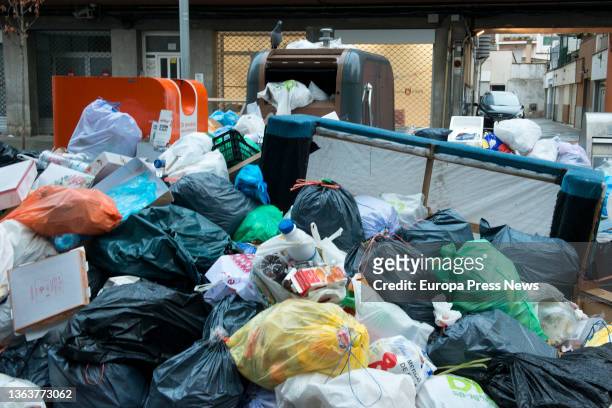 Piles of garbage bags next to a dumpster, on 10 January, 2022 in Salt, Girona, Catalonia, Spain. The garbage workers' strike in Salt has been going...